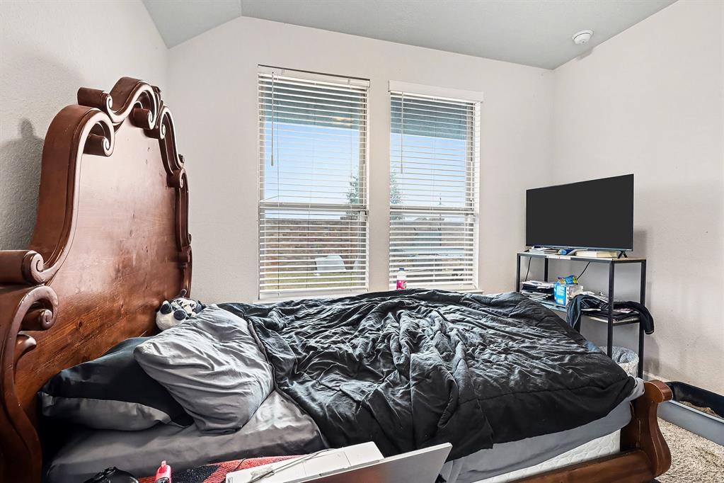 2208 Rothbury Drive Forney, TX 75126 - Photo 11 of 15 a bedroom with bed and a flat screen tv