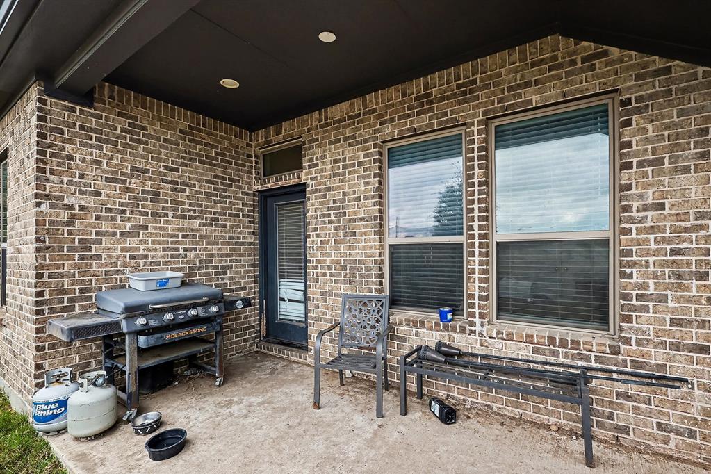 2208 Rothbury Drive Forney, TX 75126 - Photo 13 of 15 a brick building with a bench in front of it