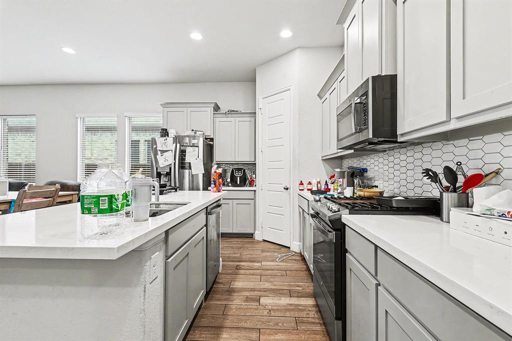 2208 Rothbury Drive Forney, TX 75126 - Photo 5 of 15 a kitchen with a sink cabinets and appliances
