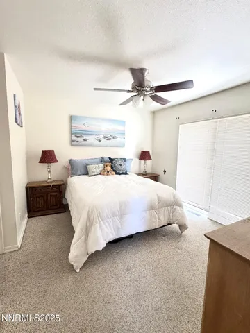a bedroom with a bed and ceiling fan