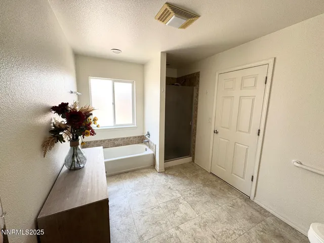 a view of hallway with chandelier and a window