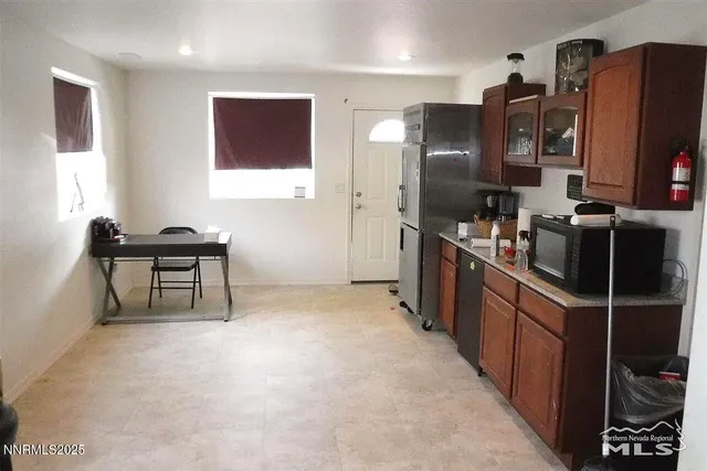 a kitchen with stainless steel appliances a refrigerator and a stove