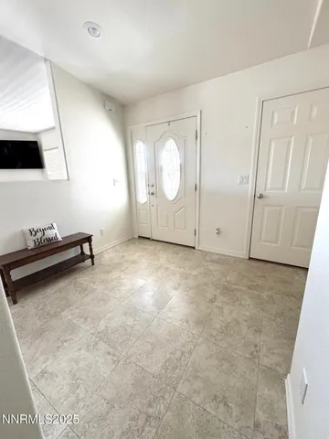 a view of a room with gym equipment and a window