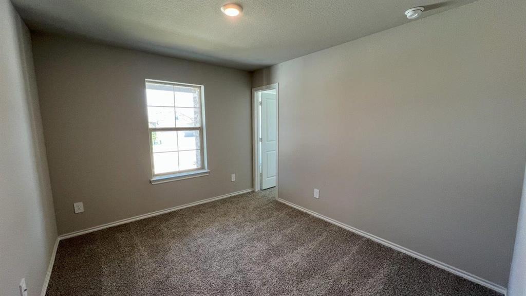 829 Round Robin Lane Rhome, TX 76078 - Photo 11 of 27 an empty room with windows