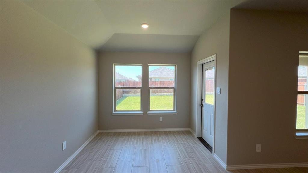 829 Round Robin Lane Rhome, TX 76078 - Photo 6 of 27 an empty room with wooden floor and windows