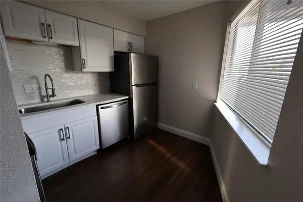 a kitchen with stainless steel appliances a refrigerator and a sink