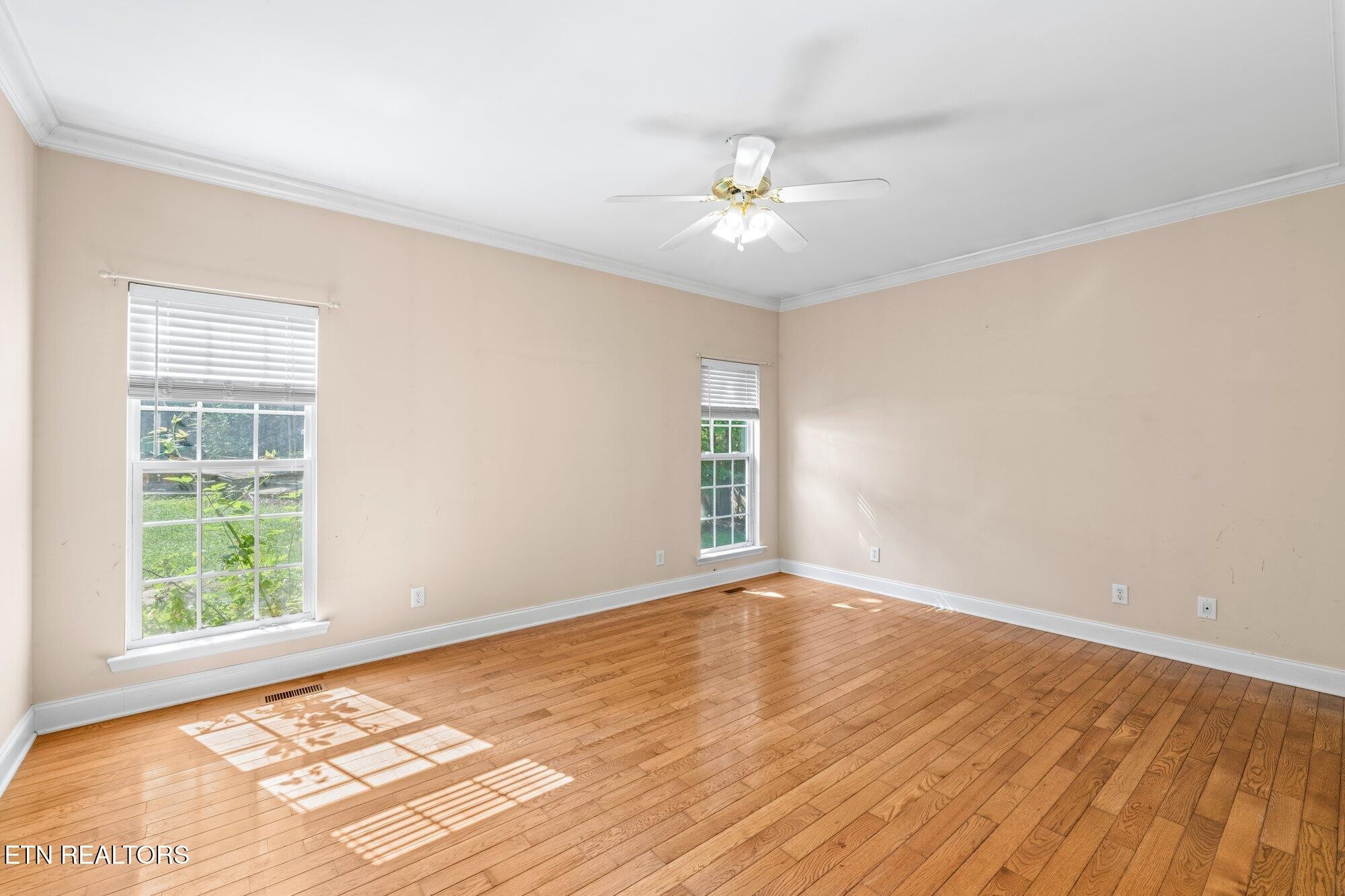 192 Savannah Ridge Trail Cleveland, TN 37323 - Photo 11 of 23 a view of an empty room with wooden floor and a window