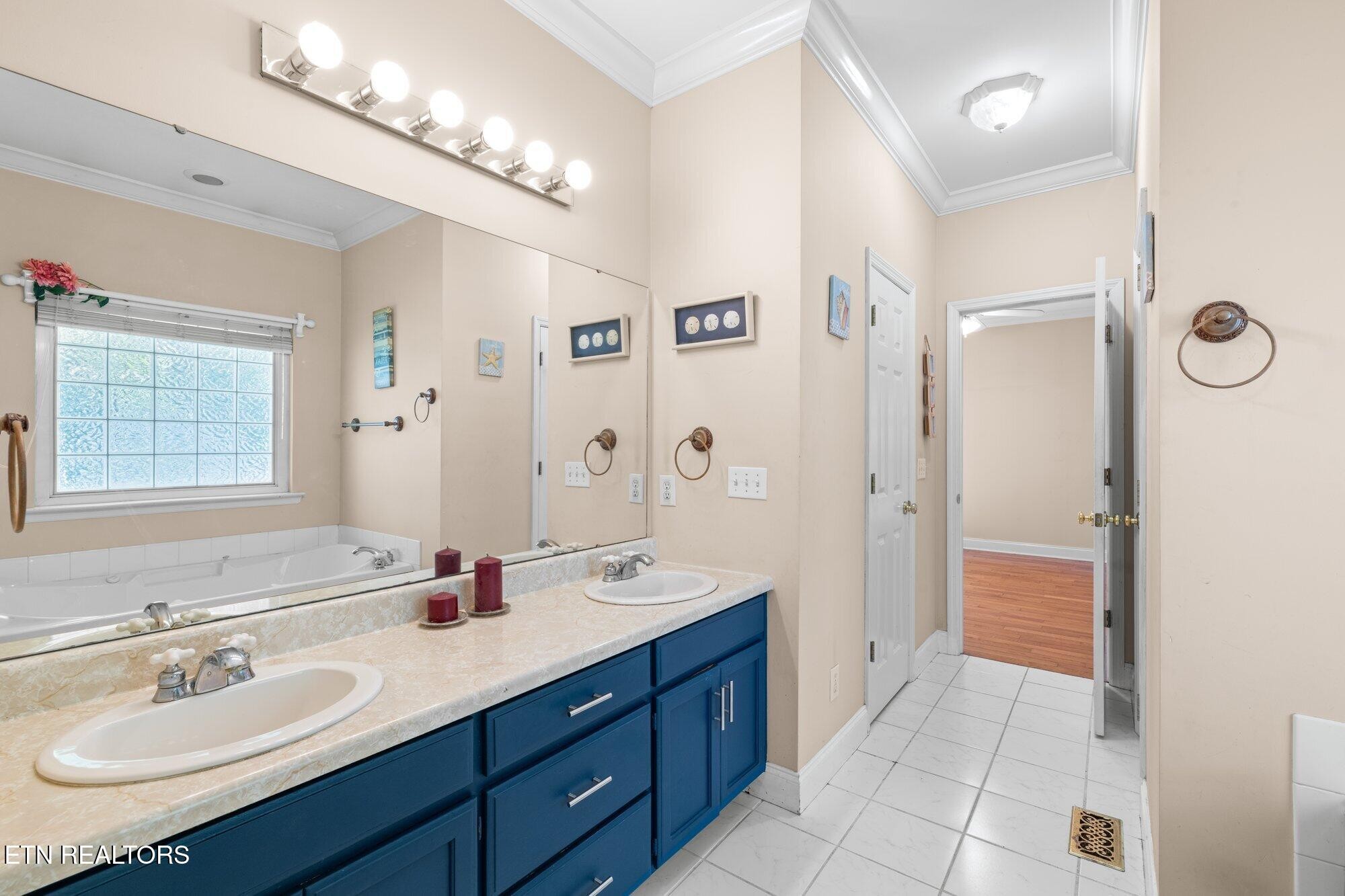 192 Savannah Ridge Trail Cleveland, TN 37323 - Photo 14 of 23 a spacious bathroom with a double vanity sink a large mirror and shower