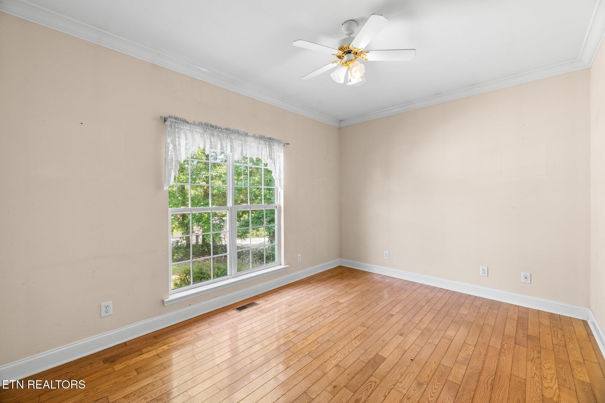 192 Savannah Ridge Trail Cleveland, TN 37323 - Photo 15 of 23 a view of an empty room with a window and wooden floor
