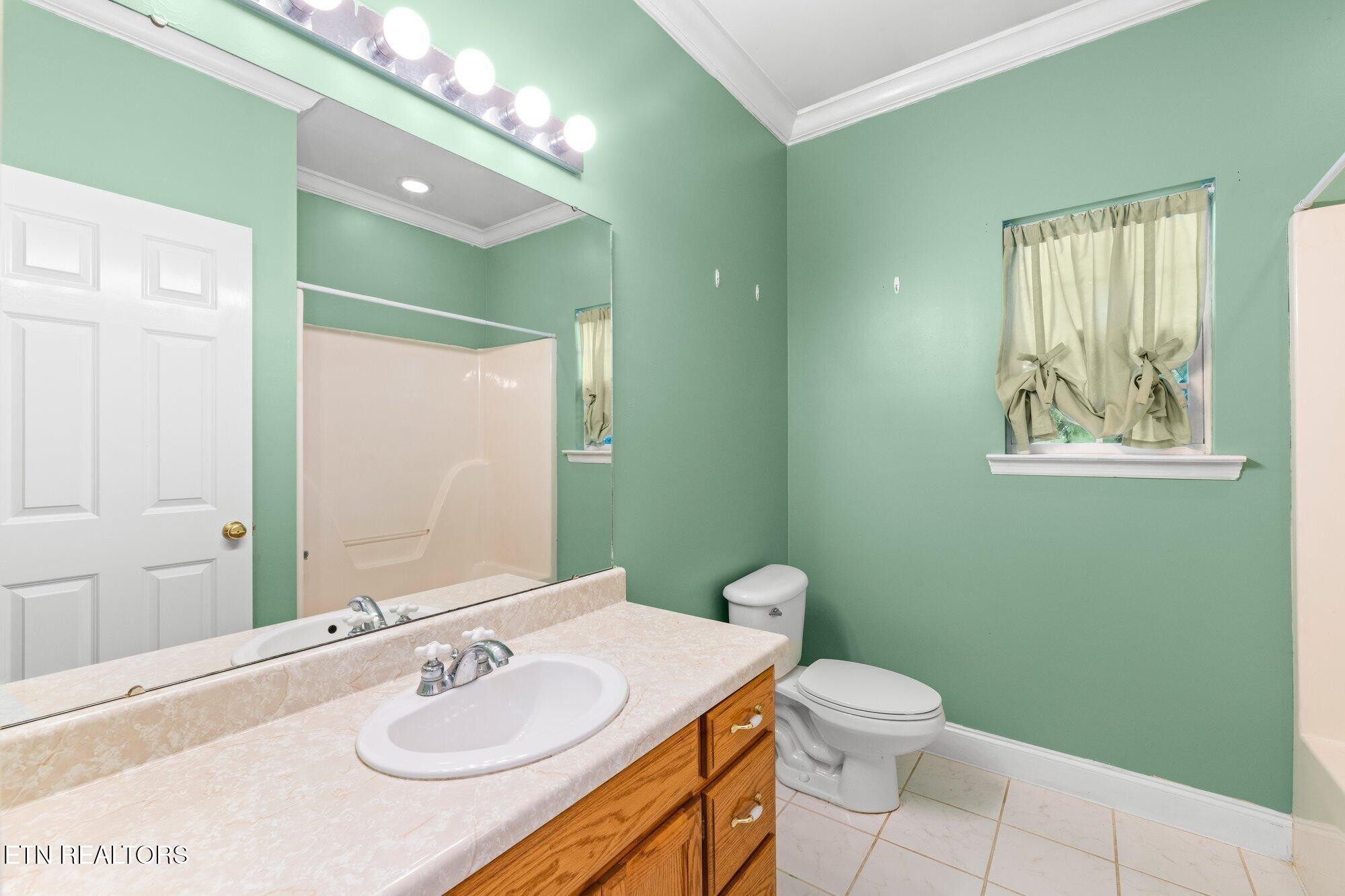 192 Savannah Ridge Trail Cleveland, TN 37323 - Photo 19 of 23 a bathroom with a sink toilet and mirror