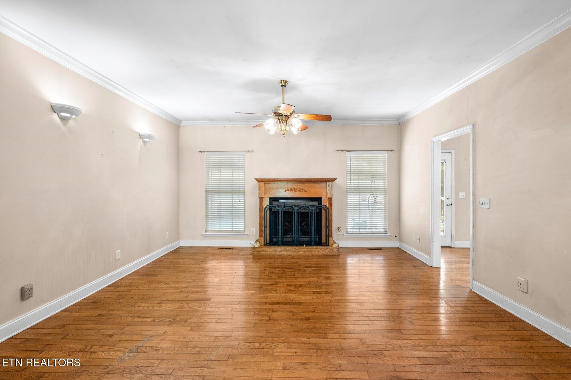 192 Savannah Ridge Trail Cleveland, TN 37323 - Photo 2 of 23 a view of an empty room with wooden floor fireplace and a window