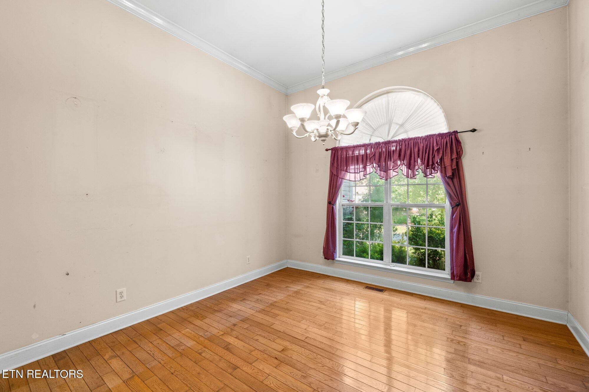 192 Savannah Ridge Trail Cleveland, TN 37323 - Photo 4 of 23 a view of a room with wooden floor and chandelier