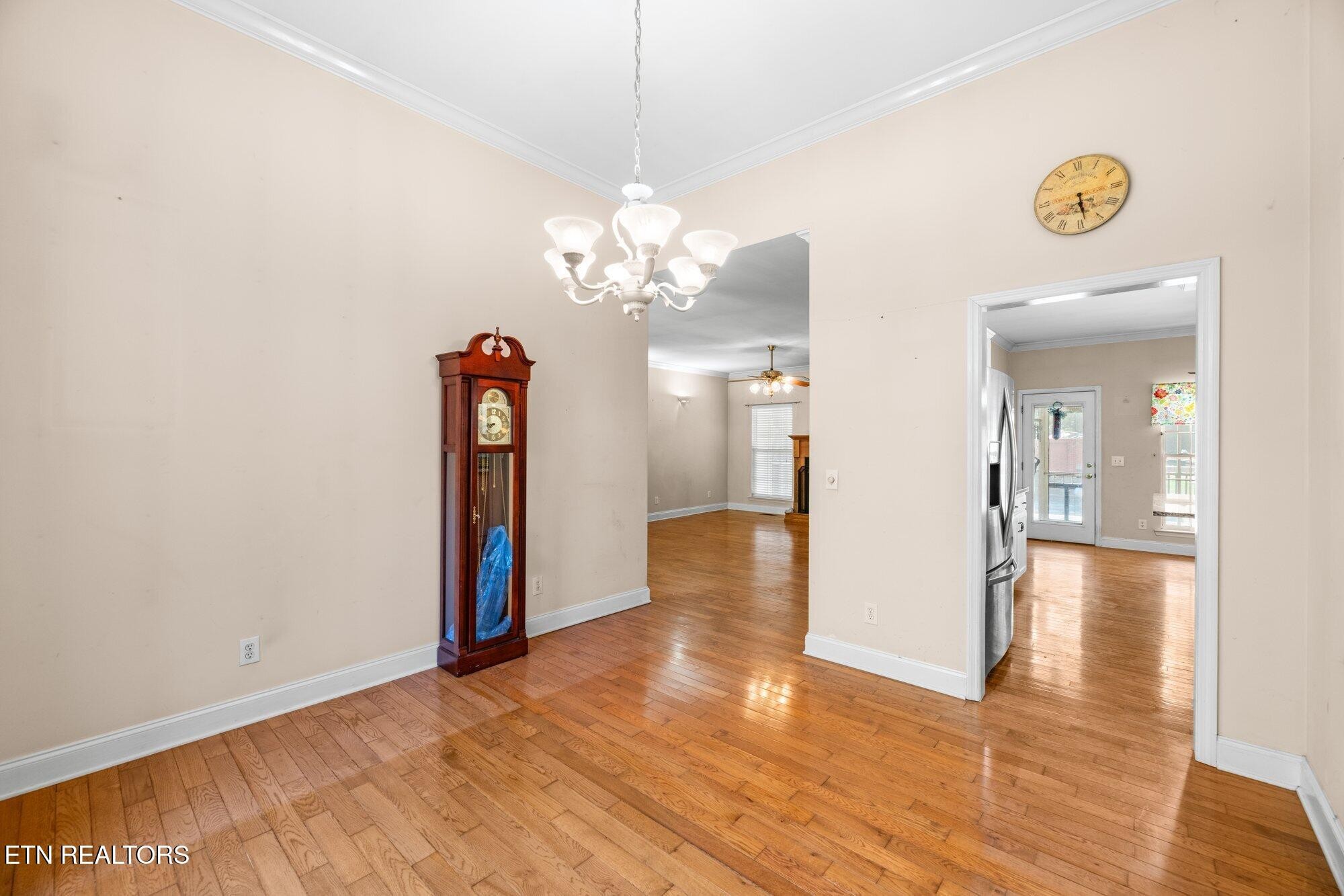 192 Savannah Ridge Trail Cleveland, TN 37323 - Photo 5 of 23 a view of a hallway with wooden floor and a chandelier