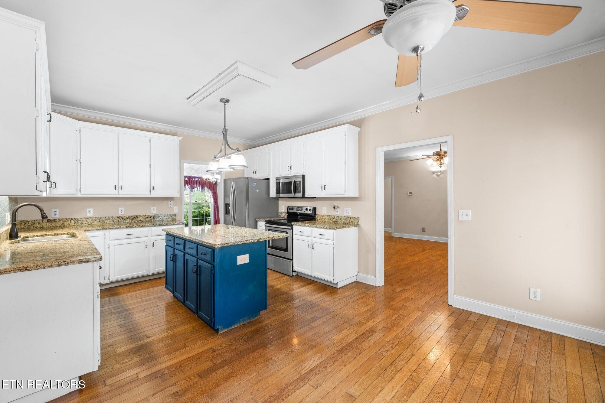 192 Savannah Ridge Trail Cleveland, TN 37323 - Photo 7 of 23 a kitchen with stainless steel appliances granite countertop a refrigerator a stove top oven a sink dishwasher and white cabinets with wooden floor