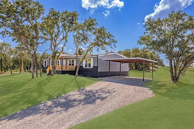 a view of house with a big yard