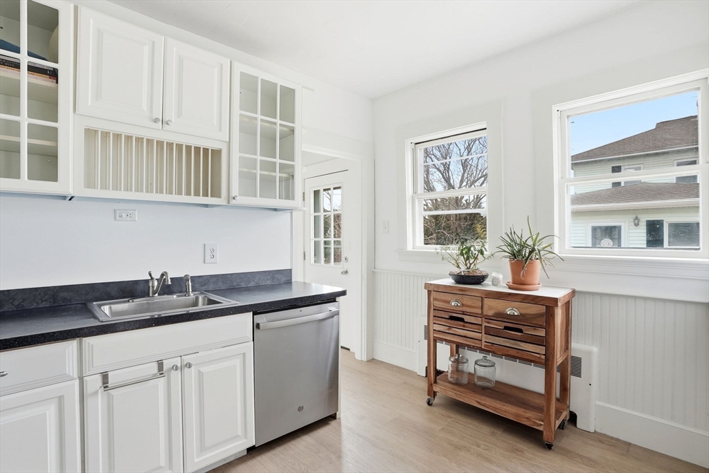 48 Bates Street Hull, MA 02045 - Photo 14 of 42 a kitchen with stainless steel appliances a sink and cabinets