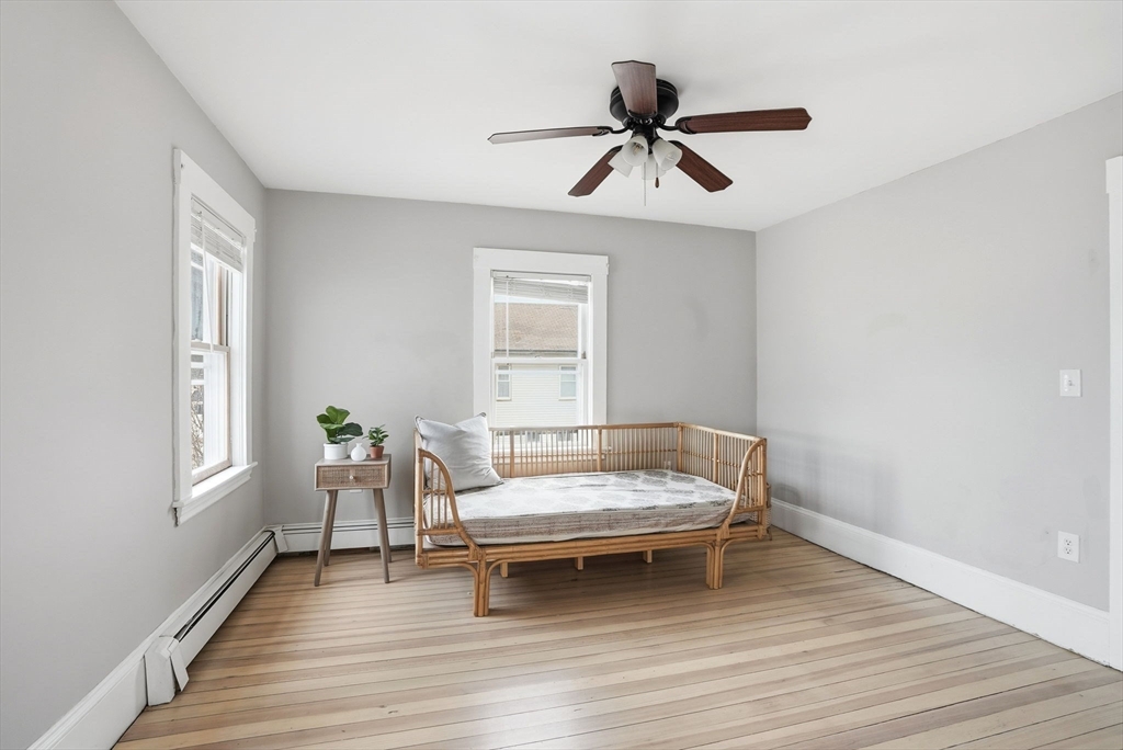 48 Bates Street Hull, MA 02045 - Photo 20 of 42 a living room with a bed furniture and a window
