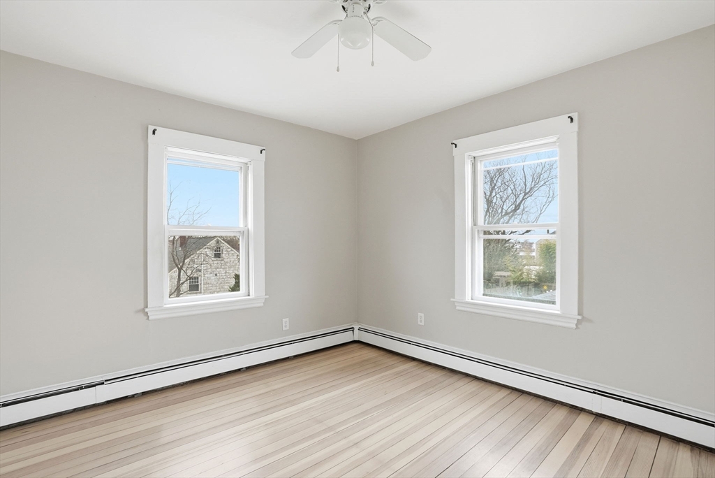 48 Bates Street Hull, MA 02045 - Photo 25 of 42 a view of an empty room with a window and wooden floor