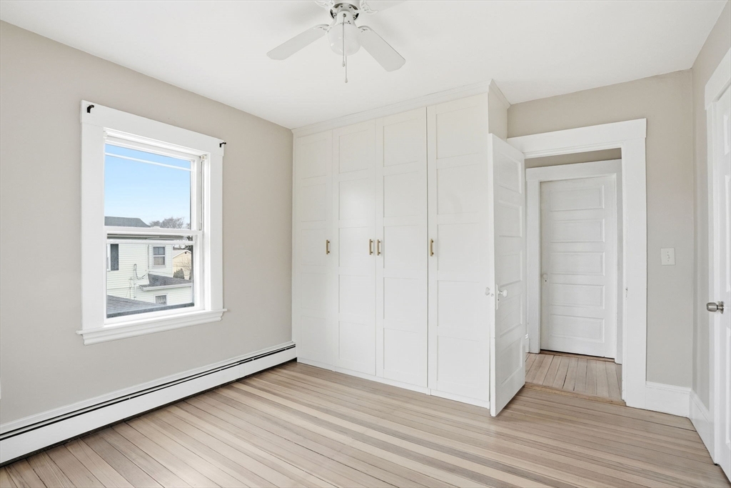 48 Bates Street Hull, MA 02045 - Photo 26 of 42 a view of an empty room with wooden floor and a window