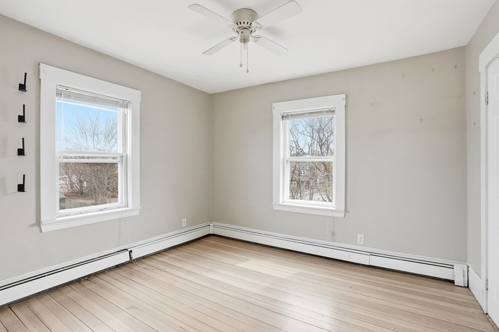 48 Bates Street Hull, MA 02045 - Photo 27 of 42 a view of an empty room with wooden floor and a window