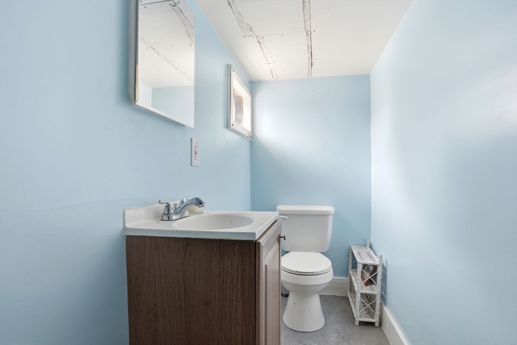 48 Bates Street Hull, MA 02045 - Photo 31 of 42 a bathroom with a toilet sink and mirror