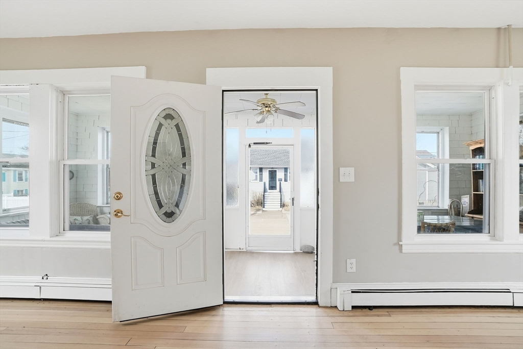 48 Bates Street Hull, MA 02045 - Photo 32 of 42 a view of a hallway with entryway wooden floor and front door