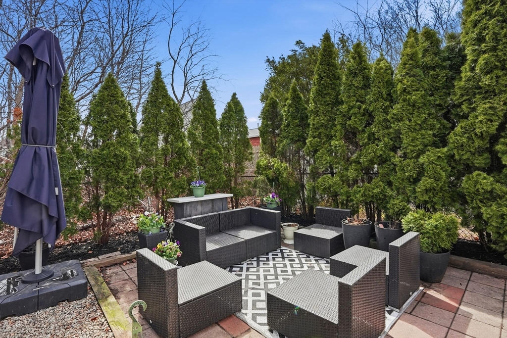 48 Bates Street Hull, MA 02045 - Photo 38 of 42 a view of a patio with couches table and chairs and potted plants
