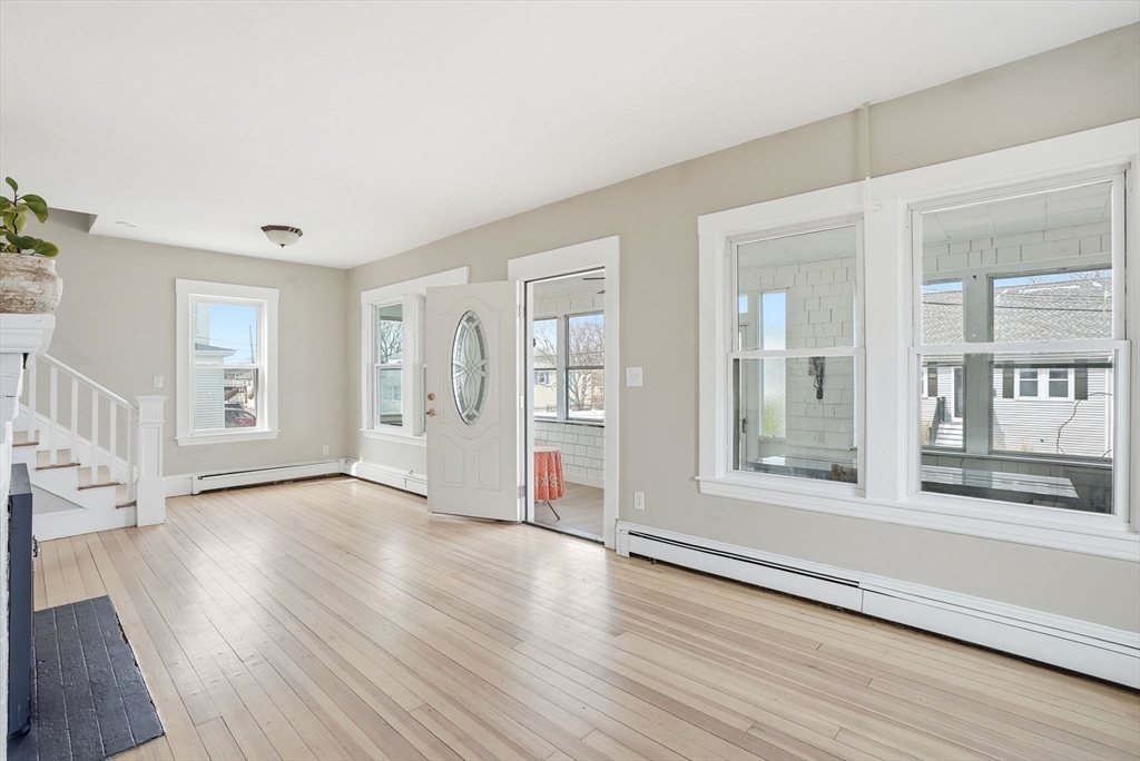 48 Bates Street Hull, MA 02045 - Photo 4 of 42 an empty room with wooden floor and windows