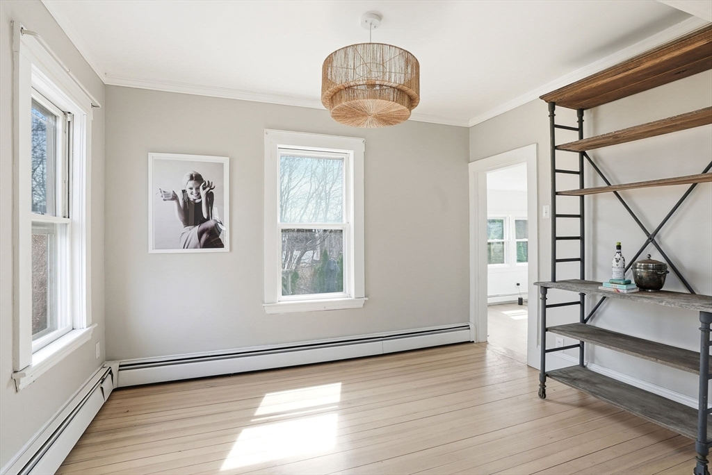 48 Bates Street Hull, MA 02045 - Photo 8 of 42 a view of an empty room with wooden floor and a window