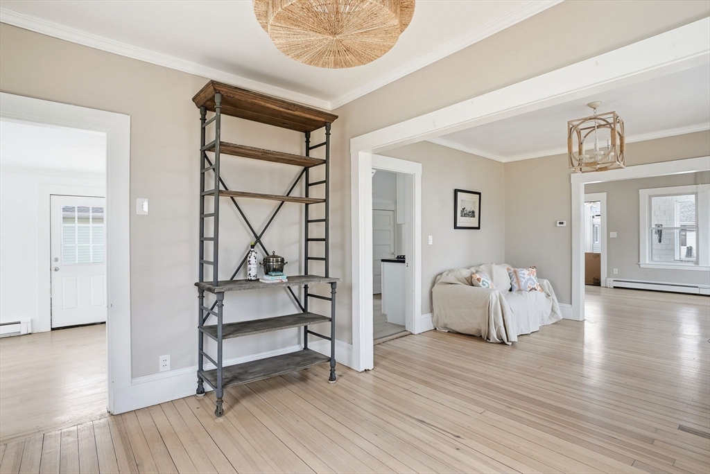 48 Bates Street Hull, MA 02045 - Photo 9 of 42 a room with wooden floors and white walls