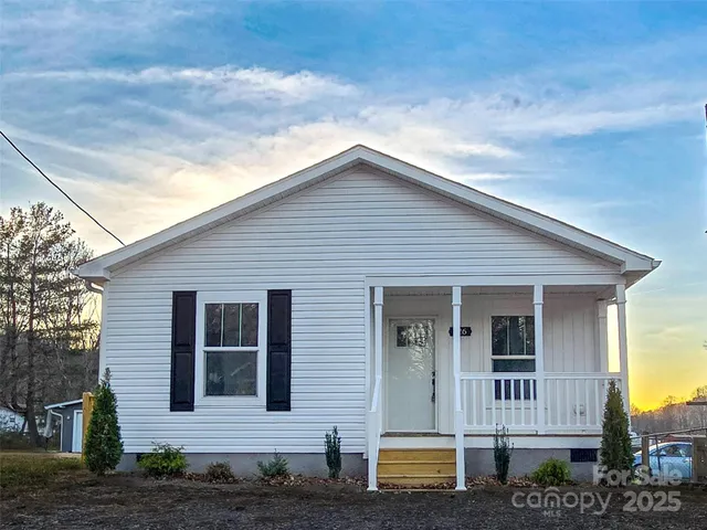 a view of front of a house with large windows