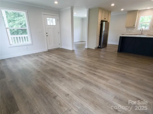 a kitchen with stainless steel appliances granite countertop a sink a refrigerator and a stove