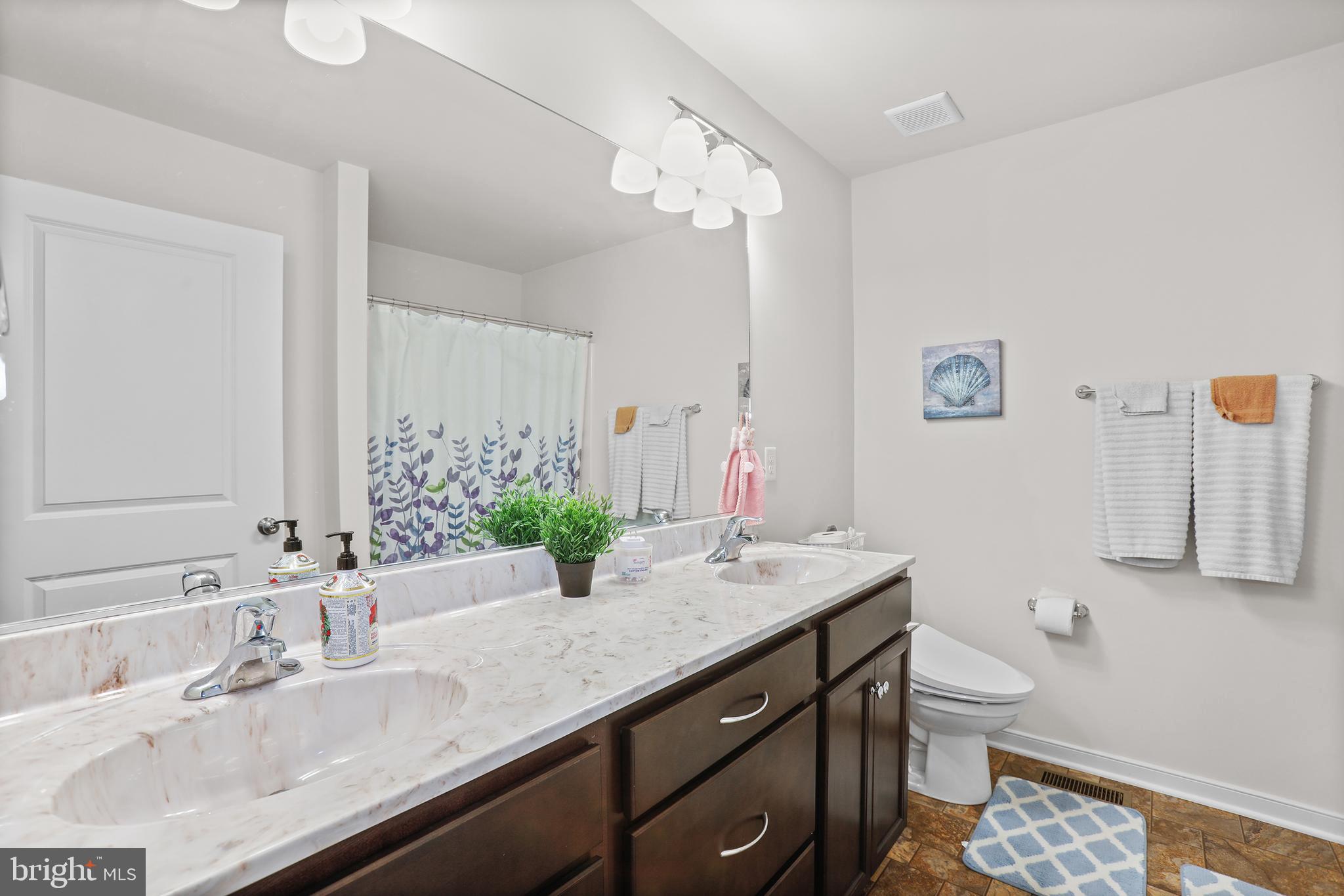 662 North Glebe Road Montross, VA 22520 - Photo 13 of 34 a bathroom with a granite countertop sink a toilet and a mirror