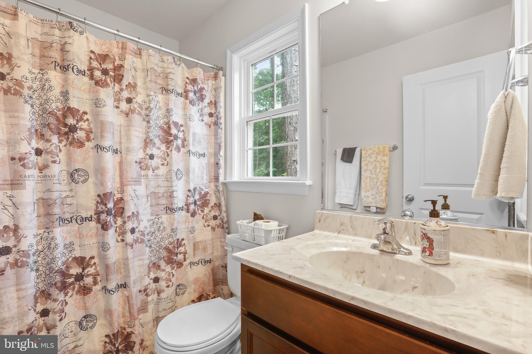 662 North Glebe Road Montross, VA 22520 - Photo 16 of 34 a bathroom with a granite countertop sink a toilet and a mirror