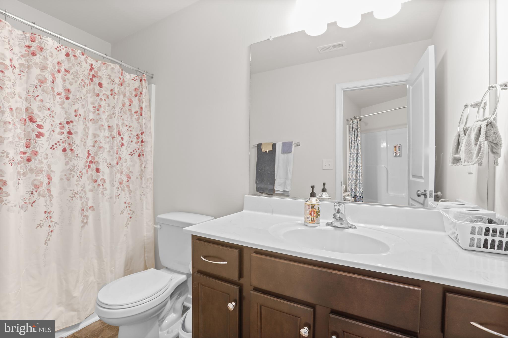 662 North Glebe Road Montross, VA 22520 - Photo 20 of 34 a bathroom with a sink a toilet and shower curtain