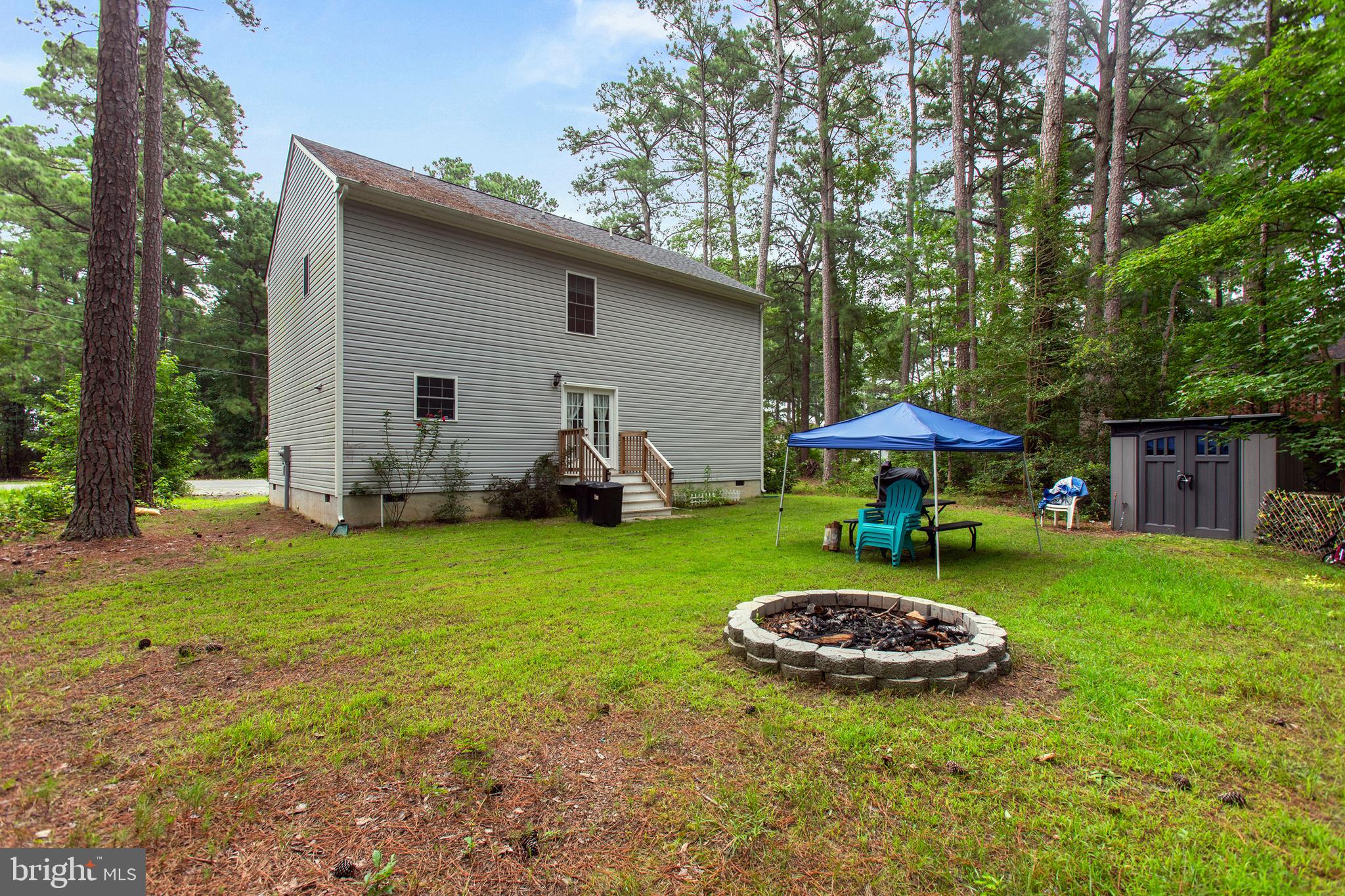 662 North Glebe Road Montross, VA 22520 - Photo 22 of 34 a view of a backyard with table and chairs under an umbrella