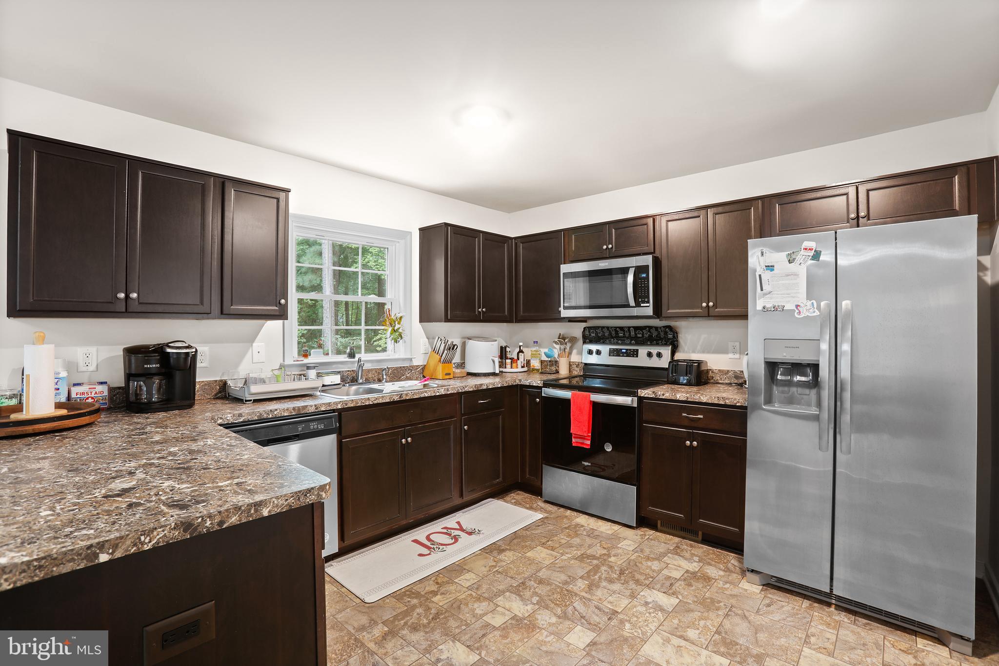 662 North Glebe Road Montross, VA 22520 - Photo 6 of 34 a kitchen with stainless steel appliances granite countertop a stove refrigerator and microwave