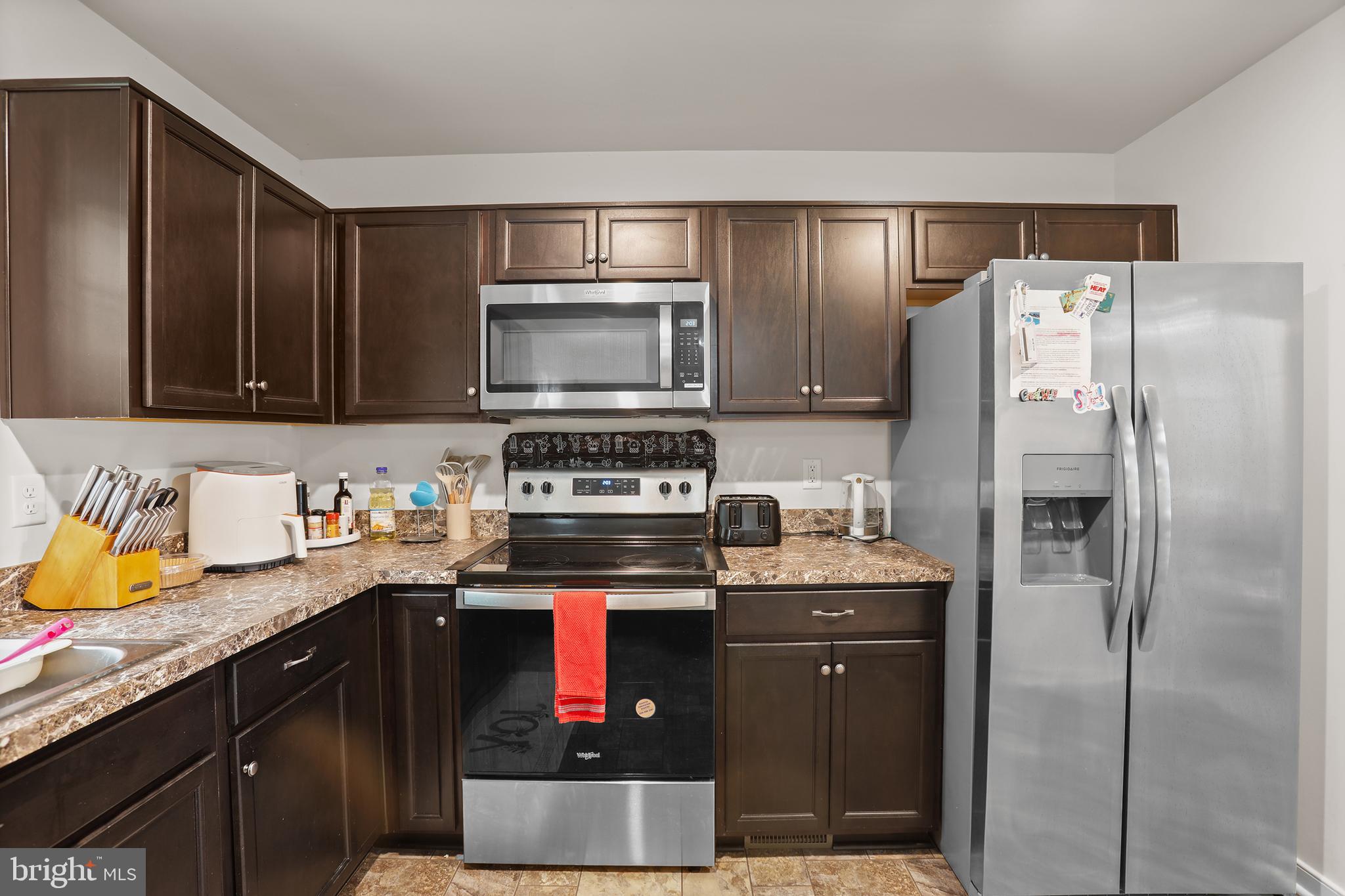 662 North Glebe Road Montross, VA 22520 - Photo 7 of 34 a kitchen with stainless steel appliances granite countertop a refrigerator stove and sink