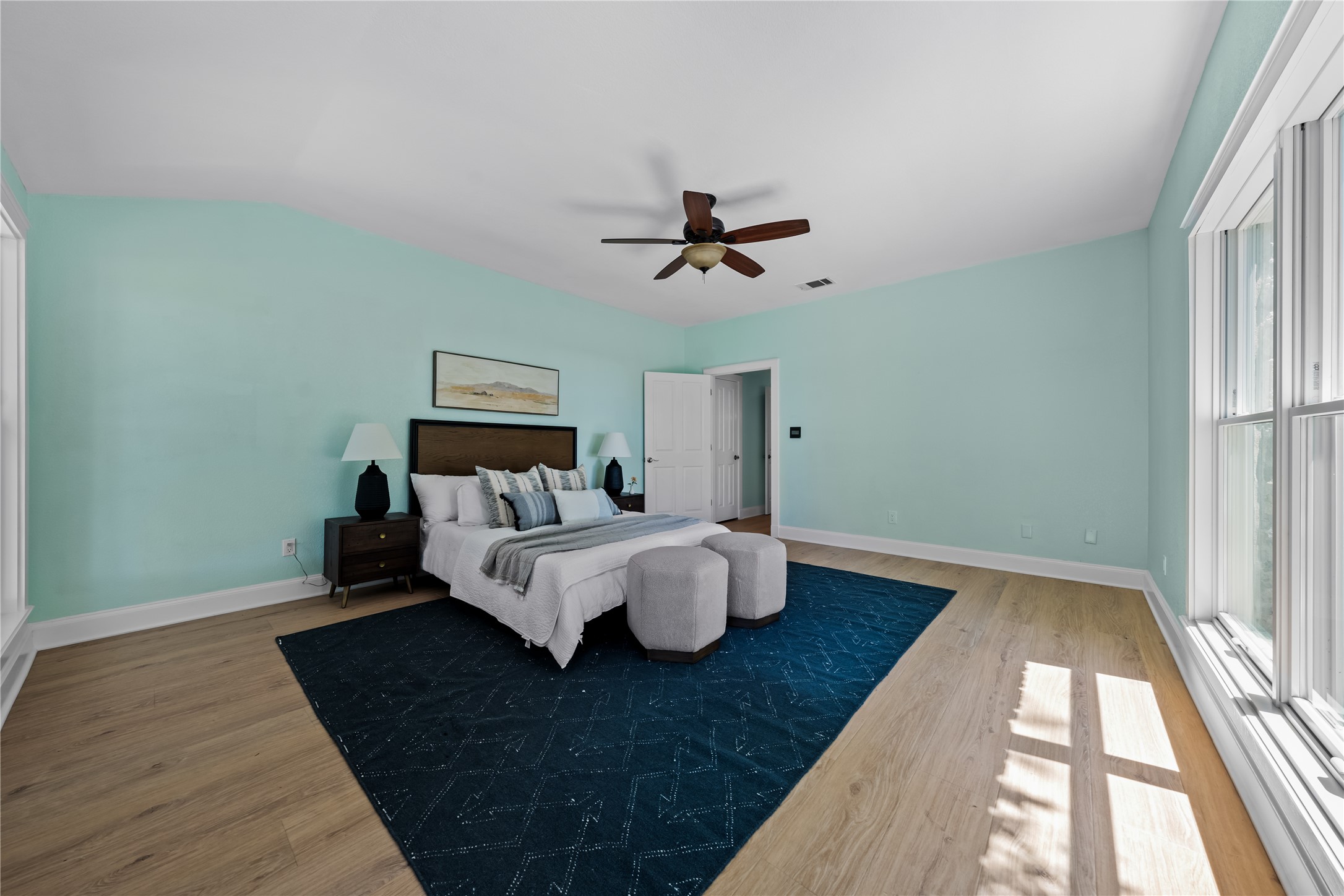 7670 Nez Perce Trace Manor, TX 78653 - Photo 10 of 40 Bedroom featuring wood finished floors, ceiling fan, baseboards, and lofted ceiling