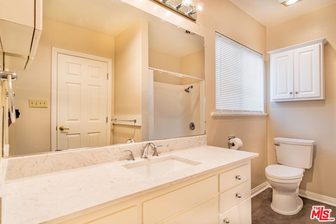 3865 Edenhurst Avenue Los Angeles, CA 90039 - Photo 13 of 22 a bathroom with a granite countertop sink toilet and shower