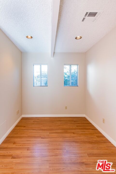 3865 Edenhurst Avenue Los Angeles, CA 90039 - Photo 15 of 22 an empty room with wooden floor and windows