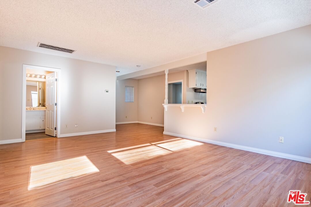 3865 Edenhurst Avenue Los Angeles, CA 90039 - Photo 5 of 22 an empty room with wooden floor and windows