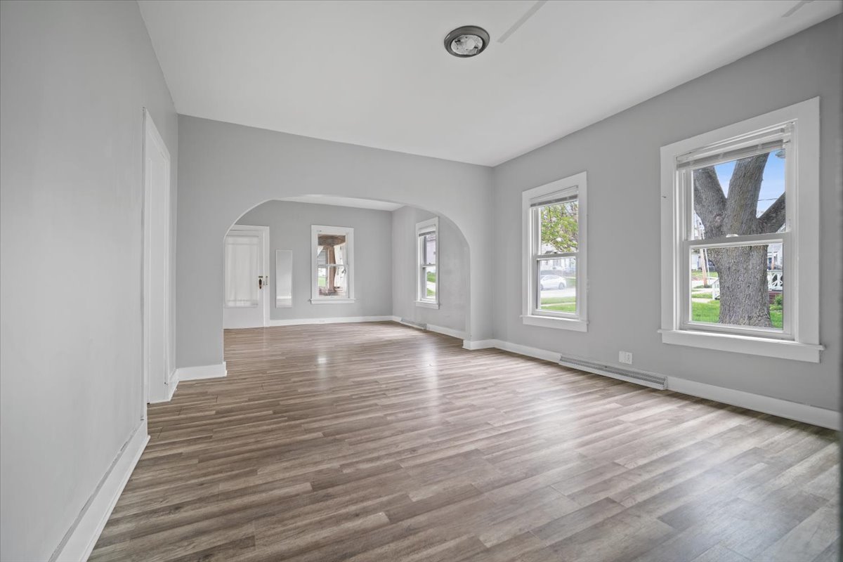 803 West Grove Street Bloomington, IL 61701 - Photo 11 of 13 a view of an empty room with wooden floor and a window