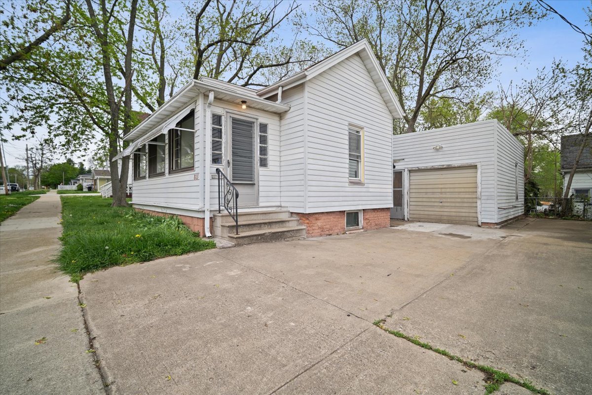 803 West Grove Street Bloomington, IL 61701 - Photo 2 of 13 a view of a house with a yard and garage