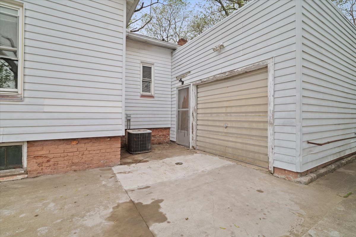 803 West Grove Street Bloomington, IL 61701 - Photo 3 of 13 a view of a house with a yard and garage