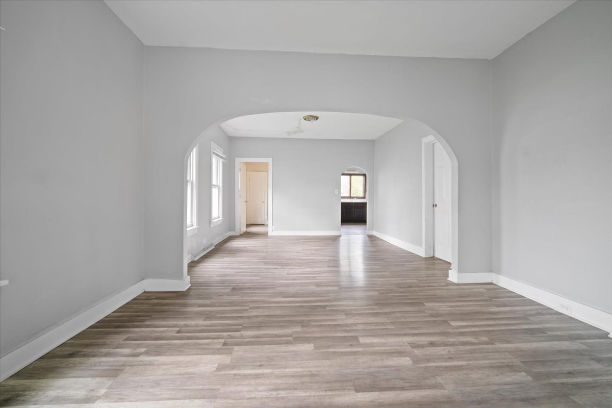 803 West Grove Street Bloomington, IL 61701 - Photo 4 of 13 a view of an empty room with wooden floor and a window