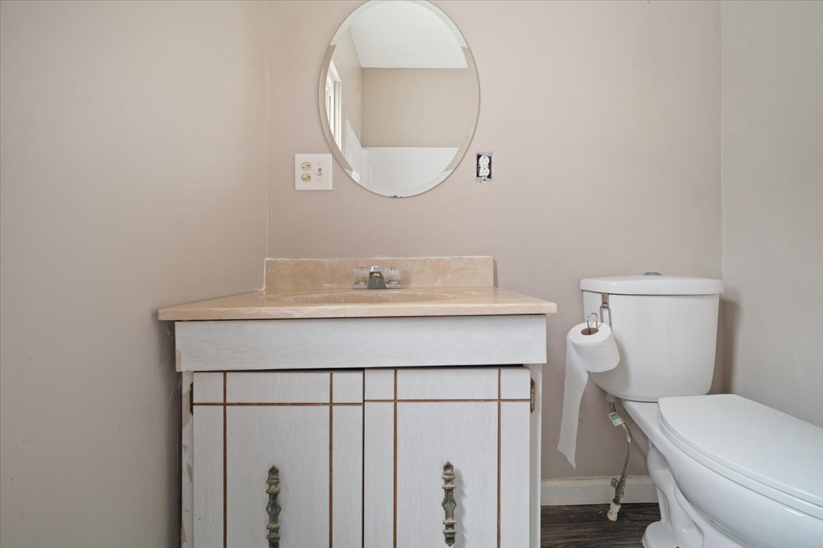 803 West Grove Street Bloomington, IL 61701 - Photo 9 of 13 a bathroom with a toilet a sink and mirror