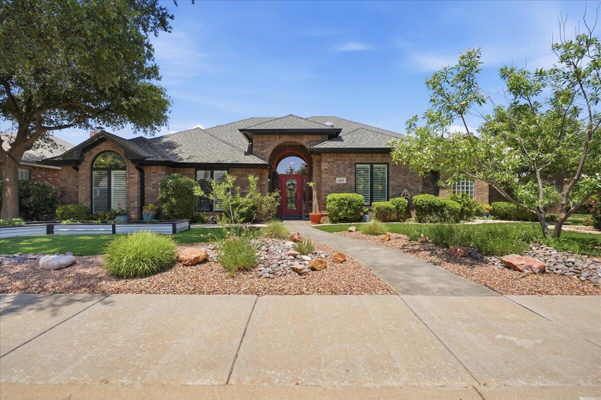 4612 100th Street Lubbock, TX 79424 - Photo 1 of 55 a front view of a house with garden