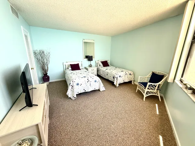 a bedroom with furniture and a flat screen tv