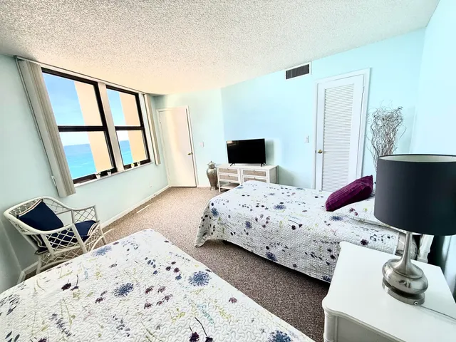 a bedroom with a bed a couch and a window